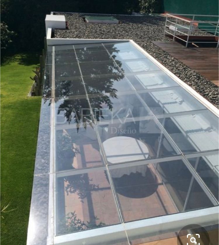 Structural glass roof over an outdoor sit-out