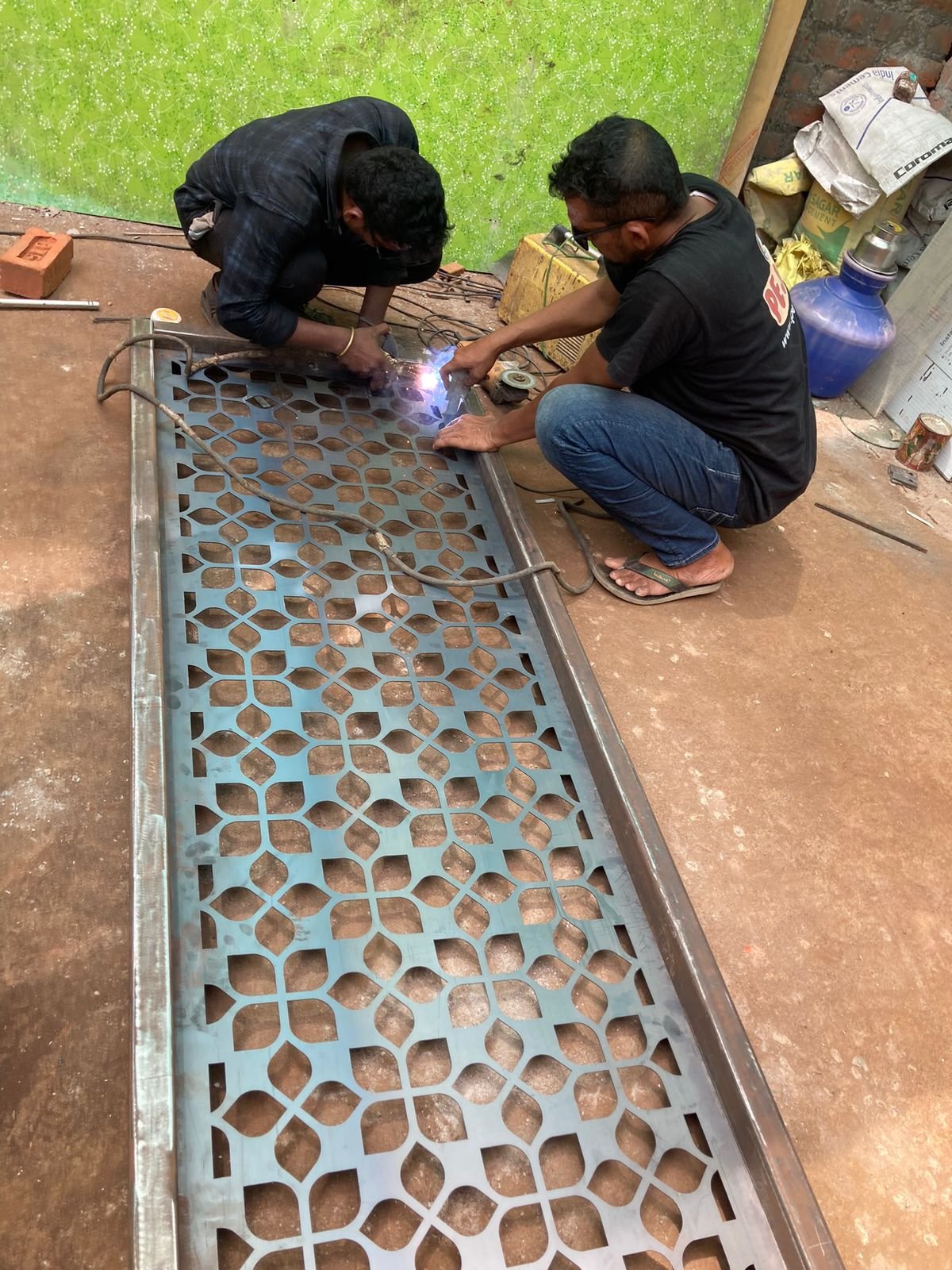 Stainless steel fabrication work in progress on a decorative metal panel