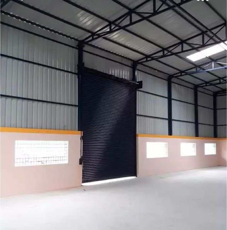 Rolling shutter fitted inside a fabricated steel shed